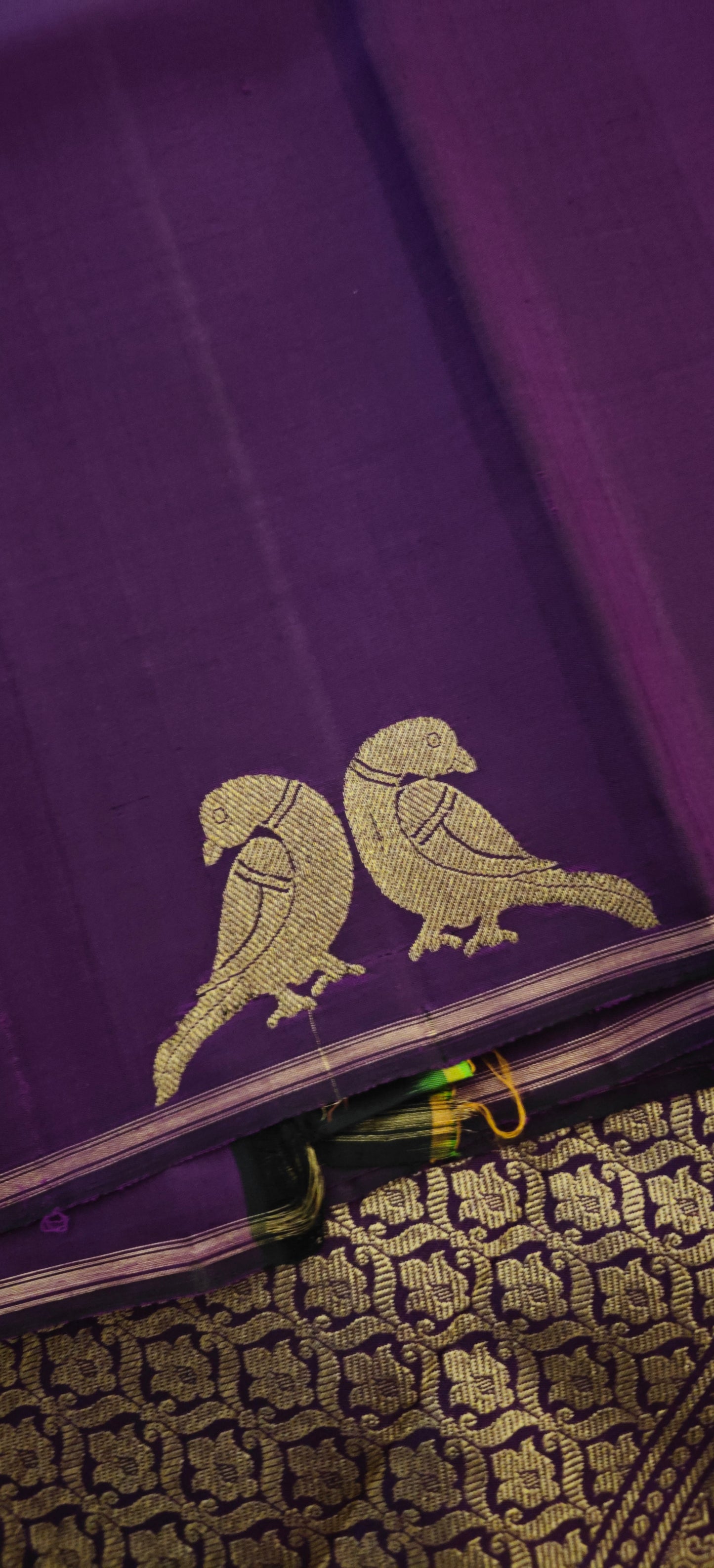 Deep purple Kanjivaram silk saree with parrot motifs